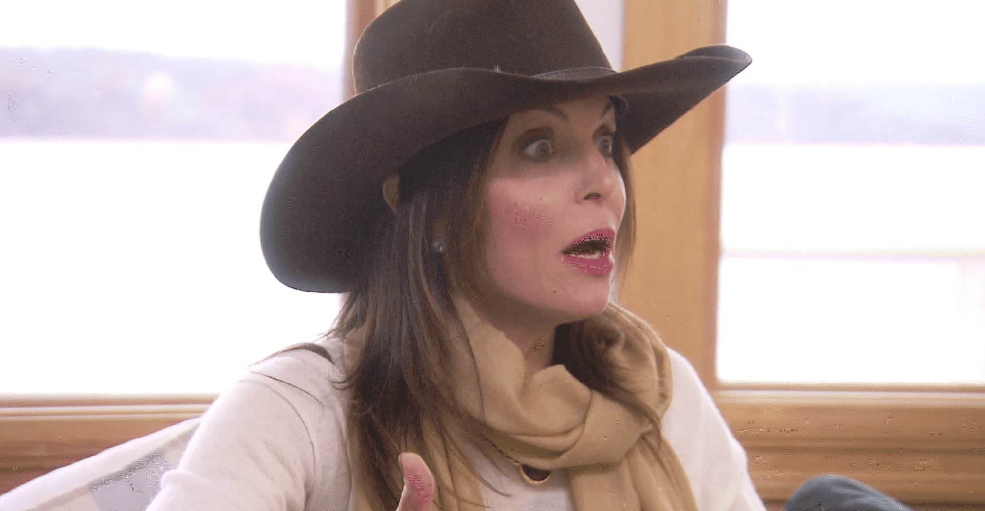 A woman wearing a cowboy hat looks stunned in this image from Ricochet Television