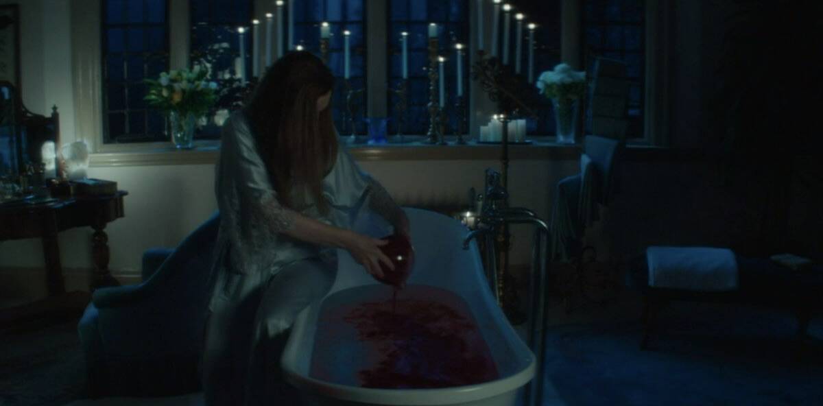 A woman pours a jar of blood into a tub in this image from CBS Television Studios.