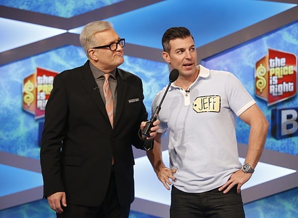 A man holds a microphone for another man in this image from The Price is Right Productions, Inc.
