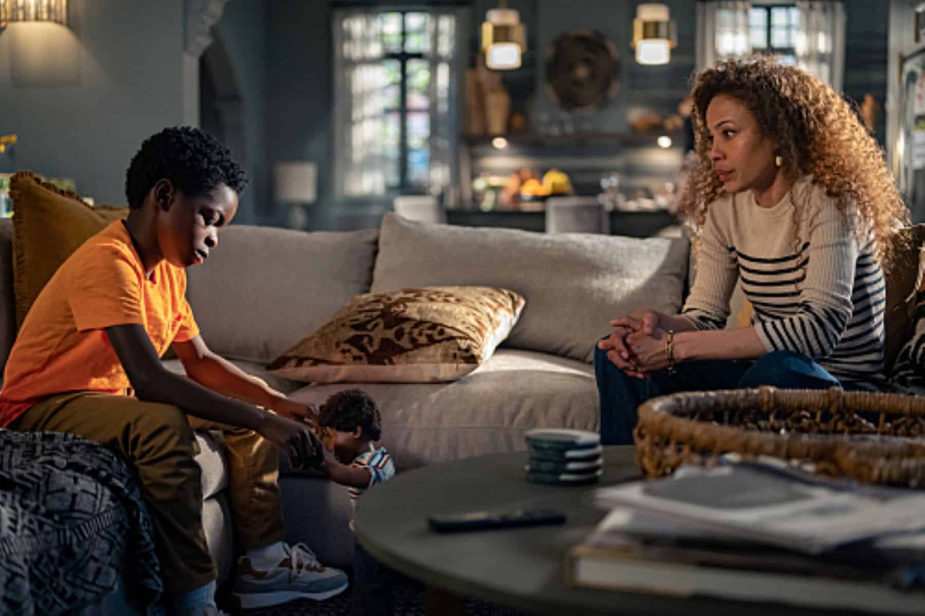 A son and his mother sit facing each other on a couch in this photo from Showtime.