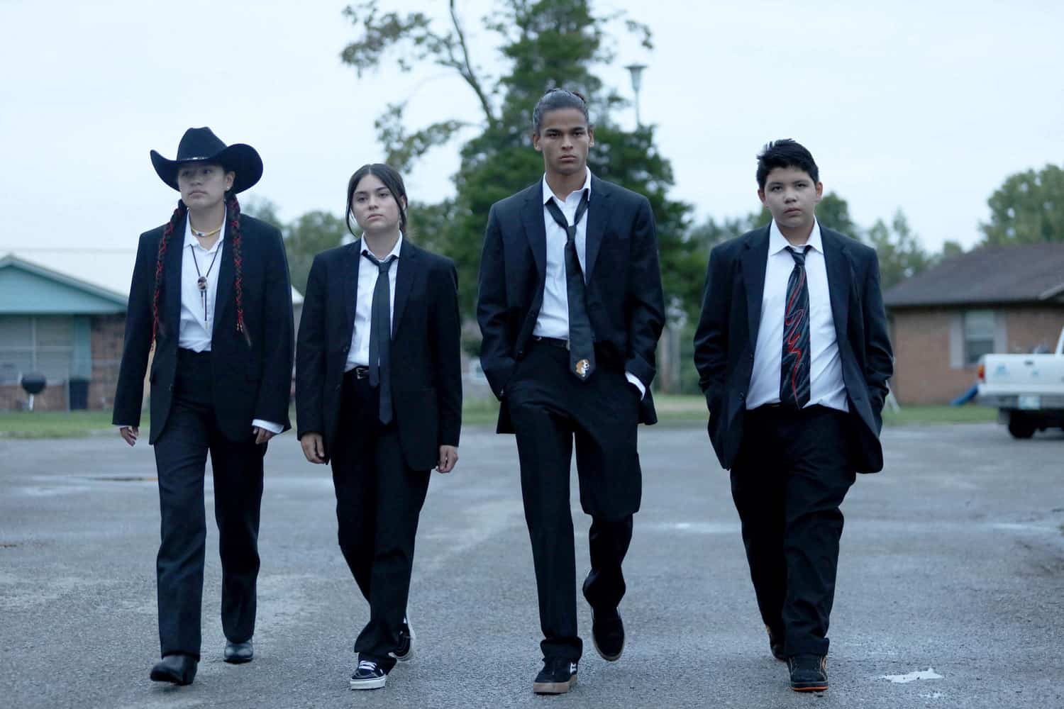 Four teens walk side by side in this image from FX Productions