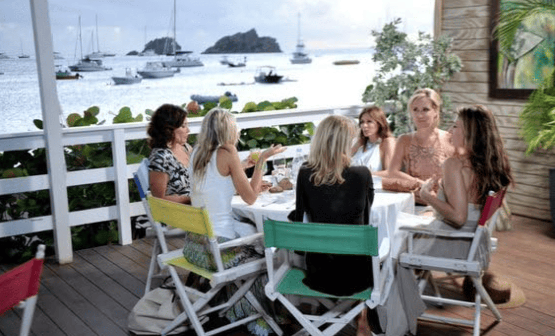 Luann de Lesseps, Carole Radziwill, Sonja Morgan, and Ramona Singer eating by the water in this image from Ricochet Television.