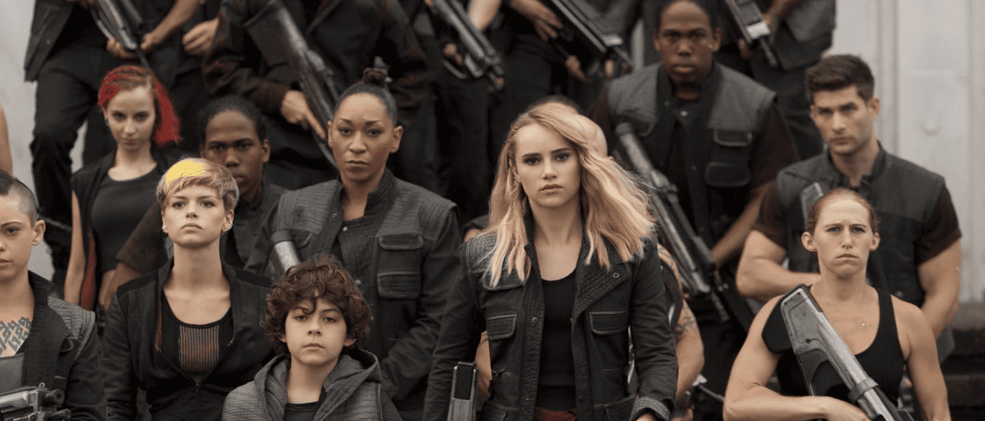 Suki Waterhouse wearing a militant outfit leading a battalion in this image from Summit Entertainment