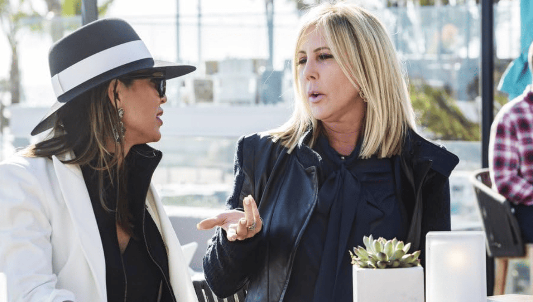 Vicki Gunvalson and Kelly Dodd are having lunch wearing matching black and white outfits in this image from Dunlop Entertainment.