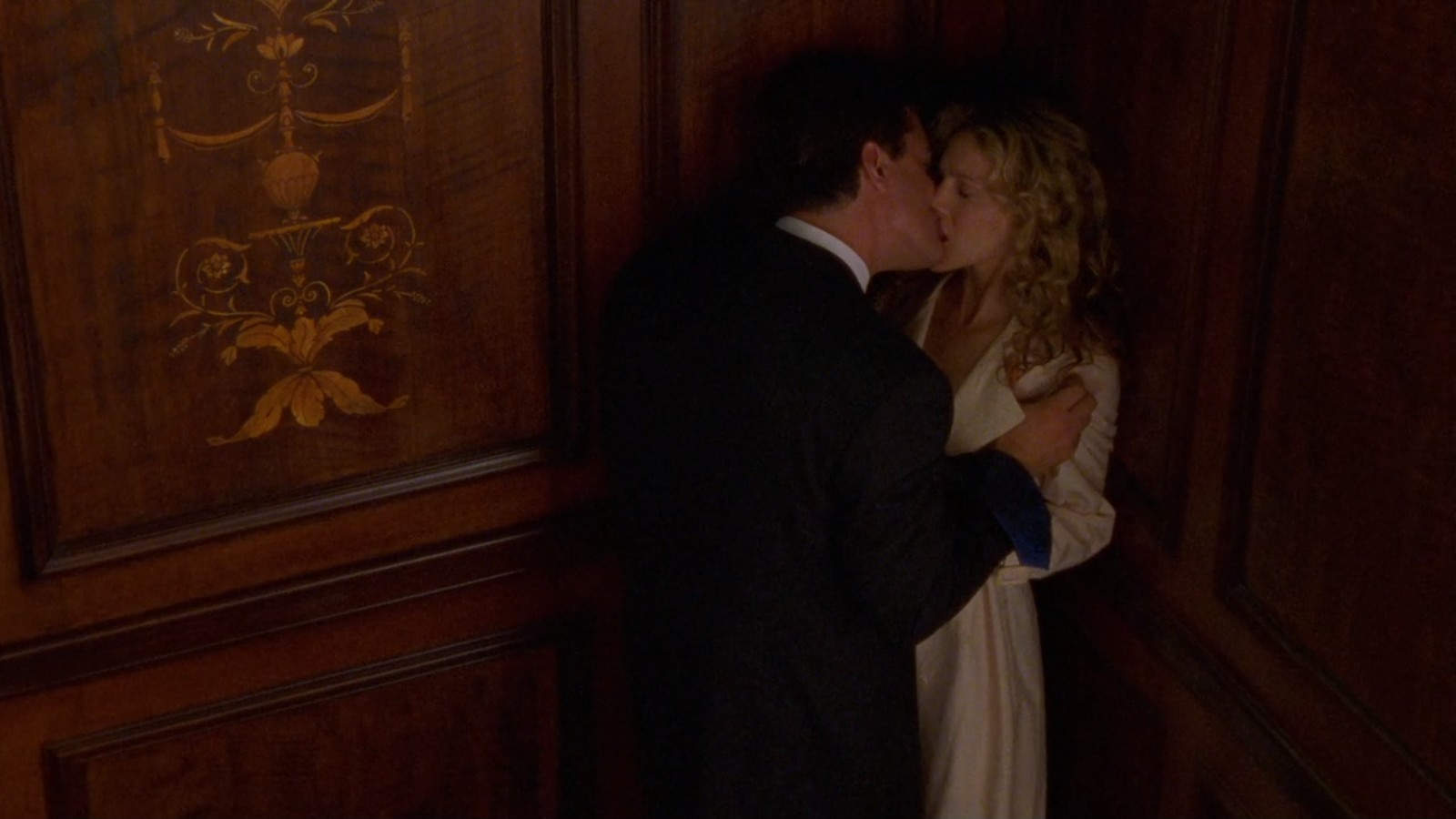 A man insistently kisses a woman in an elevator in this image from HBO Entertainment.