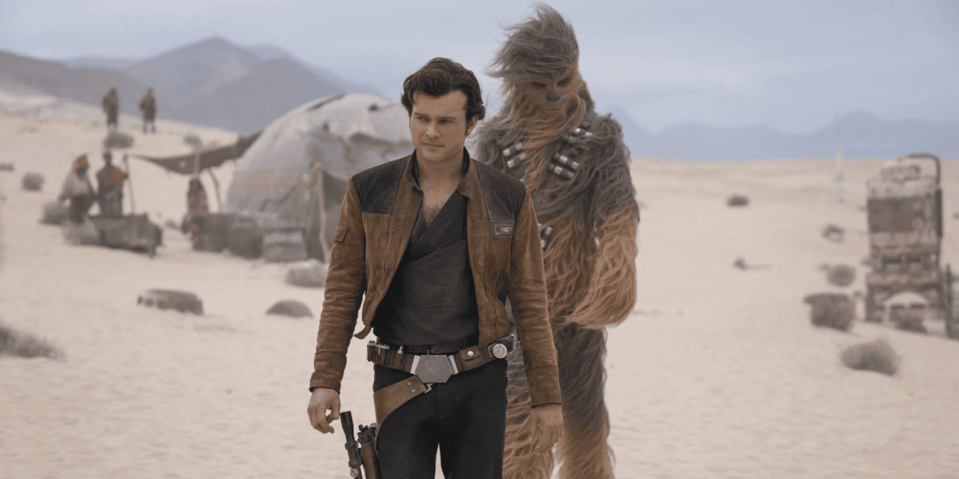 Han Solo and Chewbacca walk in a sandy wasteland in this image from Lucasfilm