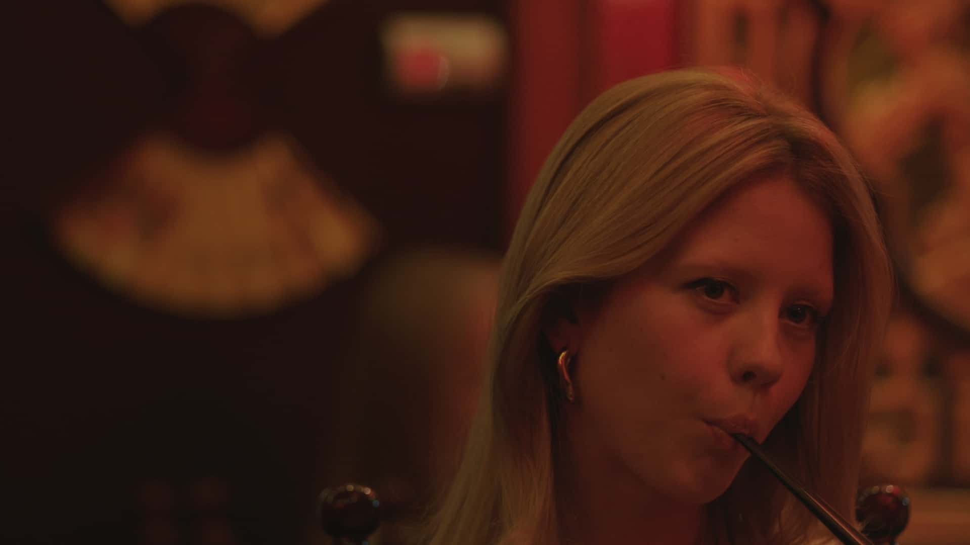 A woman sips through a straw in this image from Film Forge.