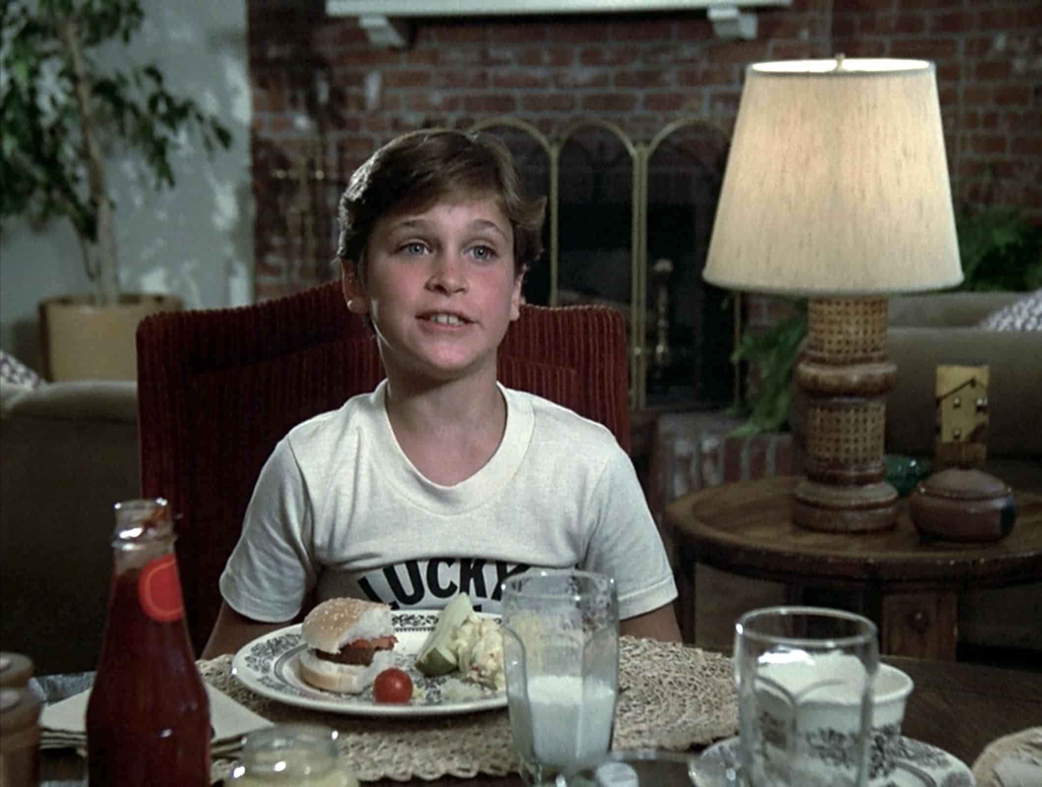 A young Joaquin Phoenix sits at the dining table in this image from Universal Television.