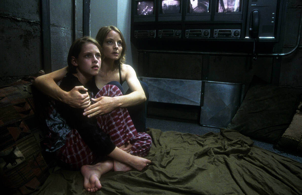 A young Kristen Stewart and Jodie Foster sit together in bed with apprehension on their faces in this image from Columbia Pictures.