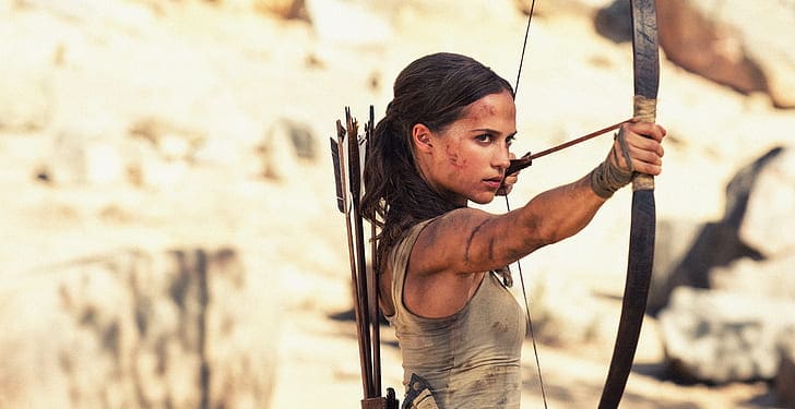  A battle-savaged Lara Croft aims her bow and arrow in this image from Warner Bros. Pictures. 