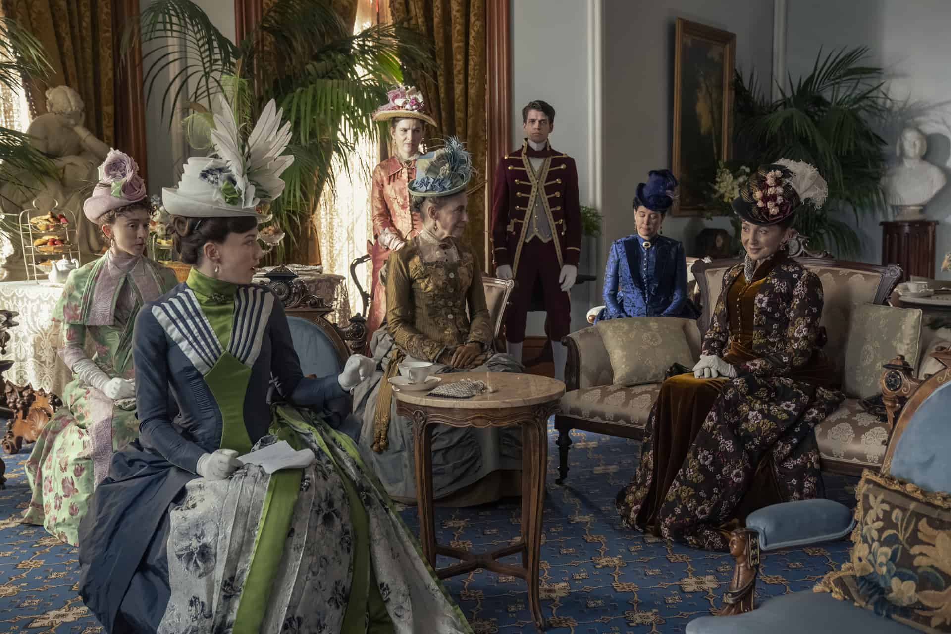 A group of lavishly dressed women in a sitting room in this image from Universal Television