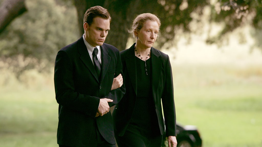 A man and a woman attend a funeral in this image from HBO Entertainment.