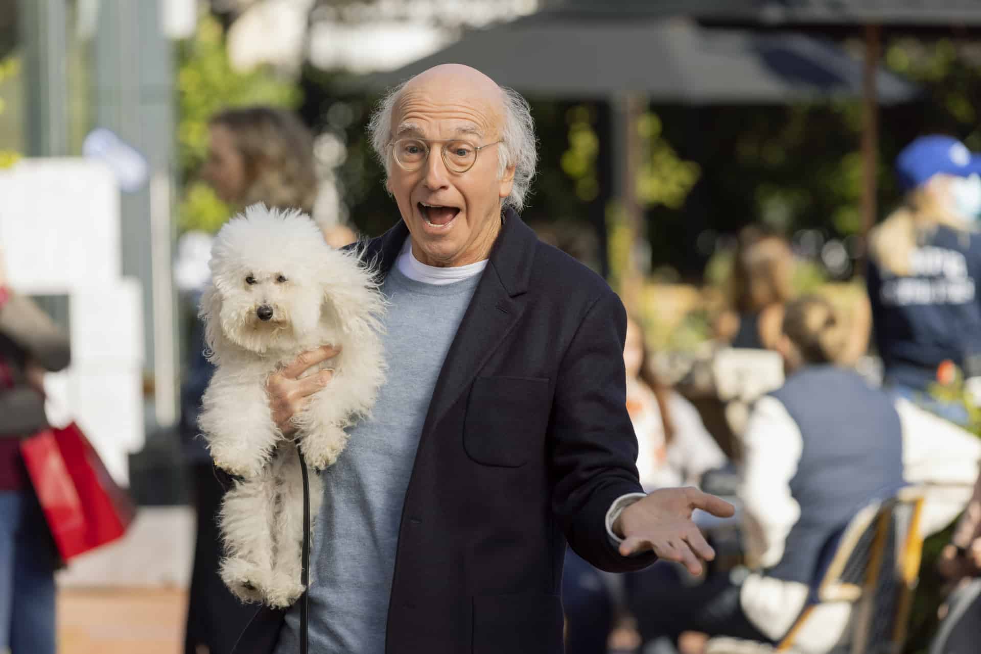 Larry David holds a white dog in this image from HBO Entertainment