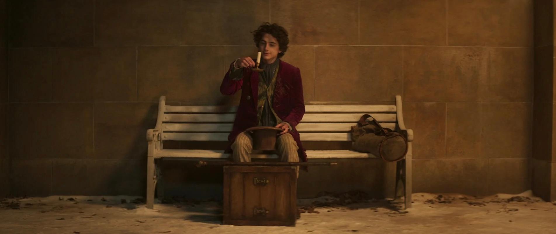 A man in a purple coat sits on a bench in this image from Village Roadshow Pictures.