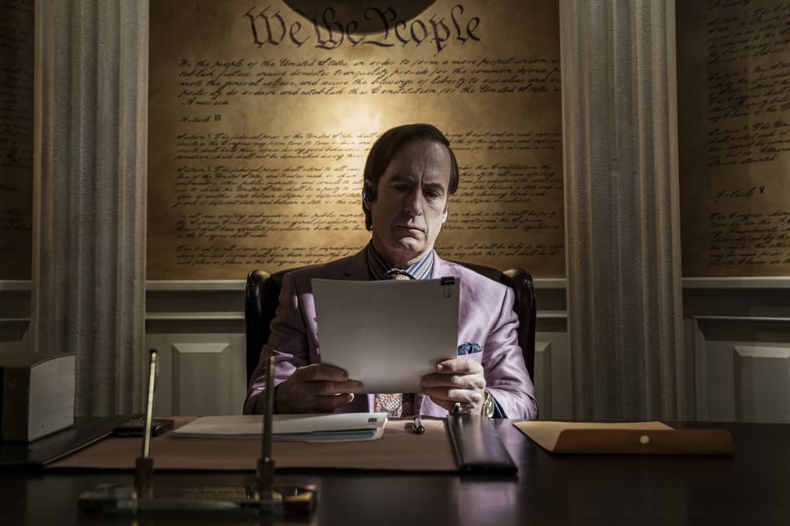 A man reads papers at his desk in this image from High Bridge Productions.