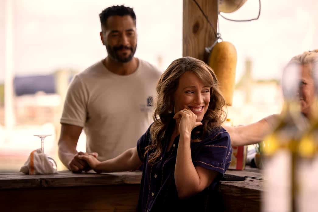 A man smiles at a woman who turns away with a smile in this image from Red Canoe Productions.