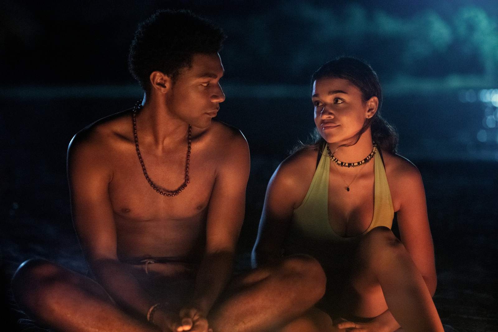 A teen boy and girl sitting in front of the bonfire in this image from Red Canoe Productions.