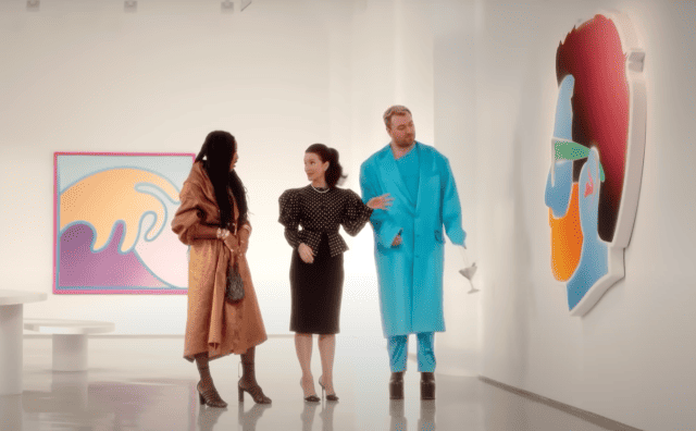 Two women and Sam Smith walk through an art exhibit in this image from HBO Entertainment.