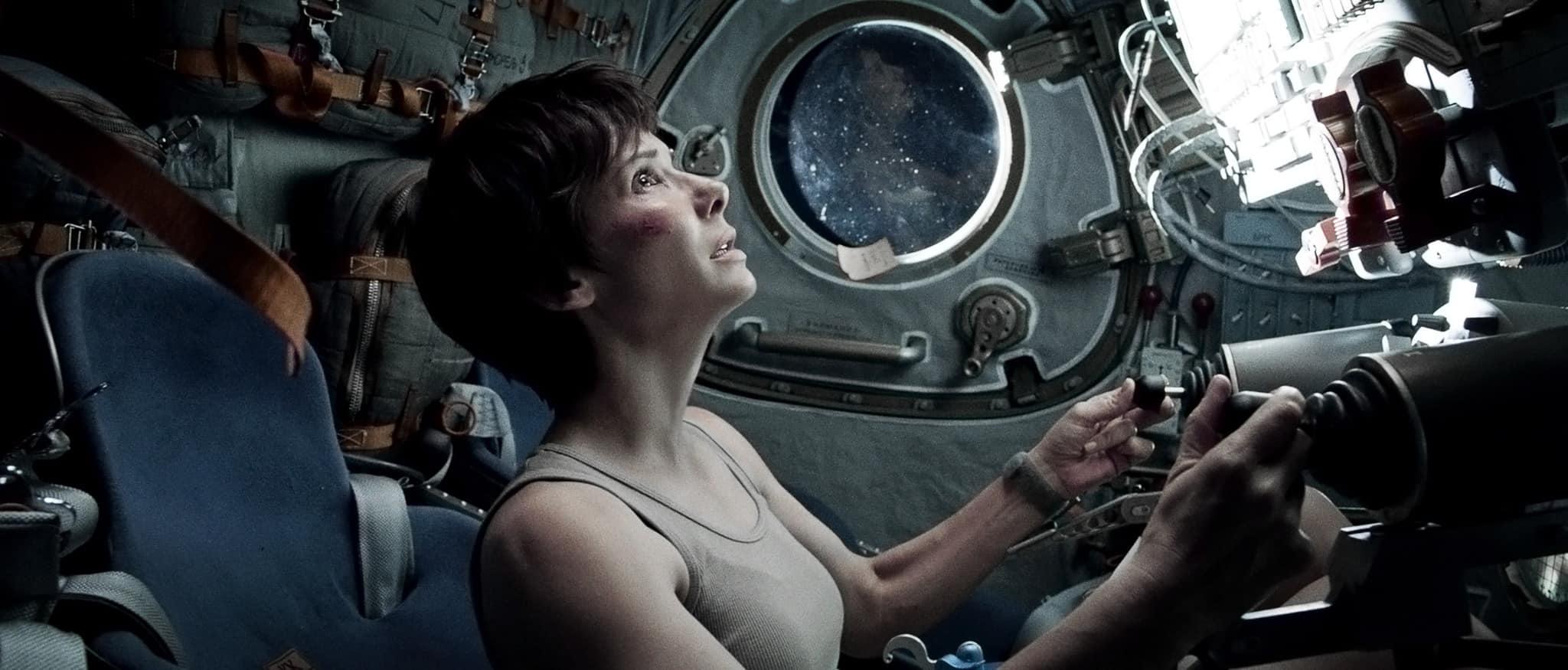 A short-haired woman operates a spaceship in this image from Warner Bros.
