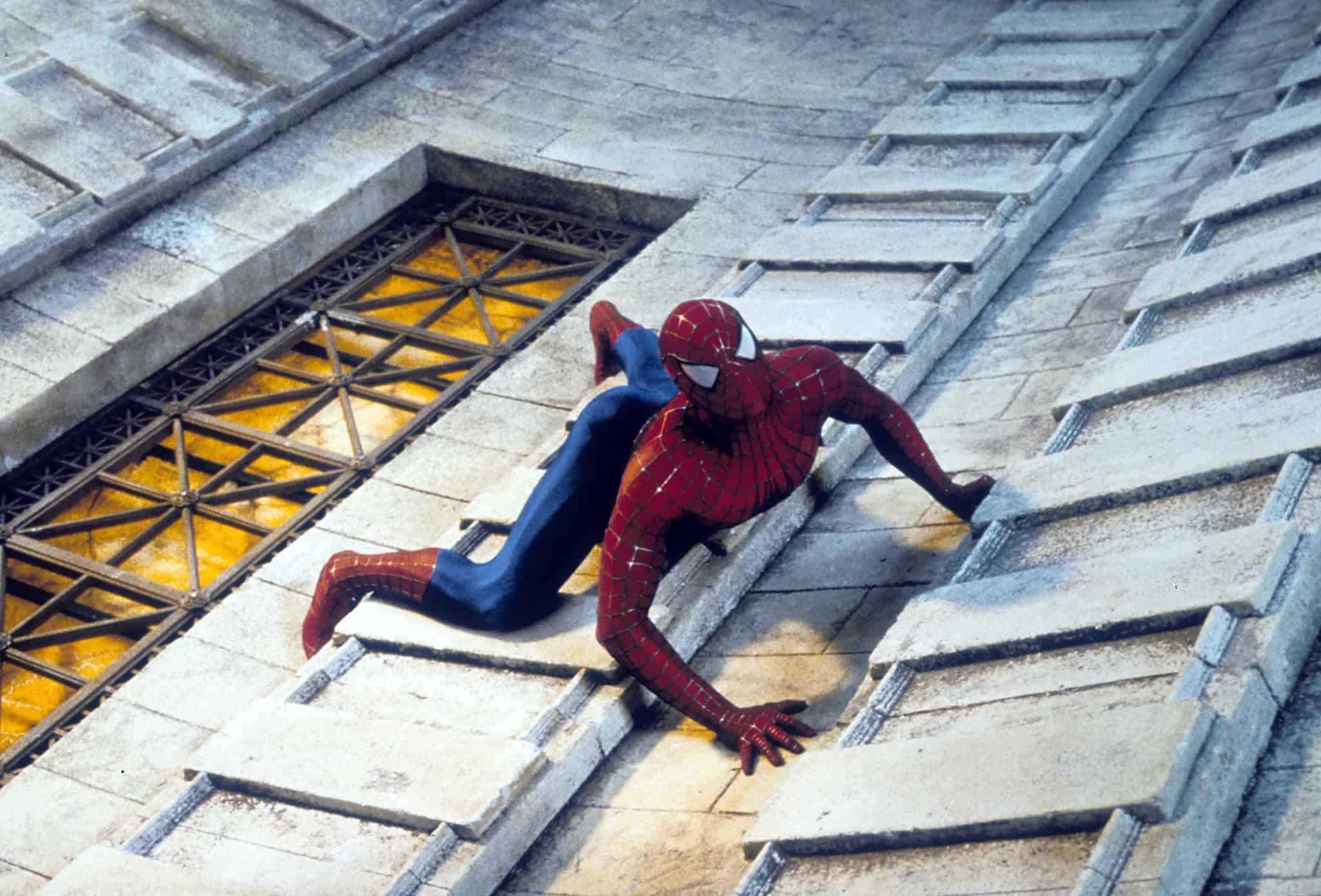 Spider-Man scales a building in this image from Columbia Pictures