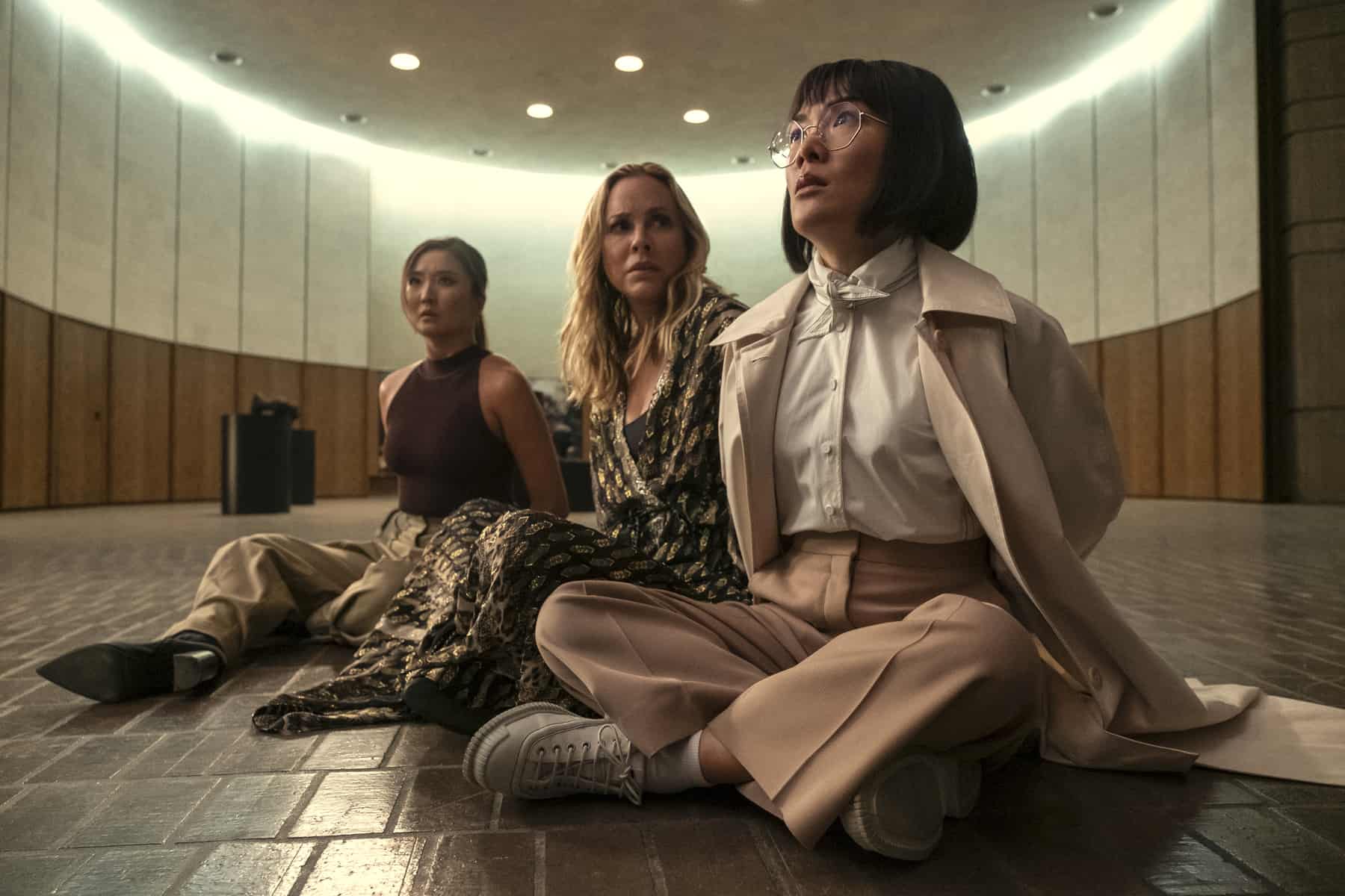 Three women are seated on the floor with hands bound in this image from A24.