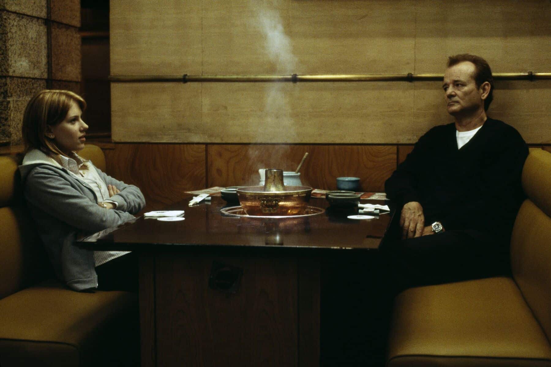 A woman and a man sit in a restaurant in this image from Focus Features