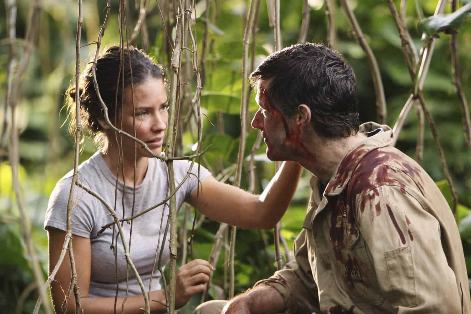A woman touching a man’s face through vines in the jungle in this image from Bad Robot.