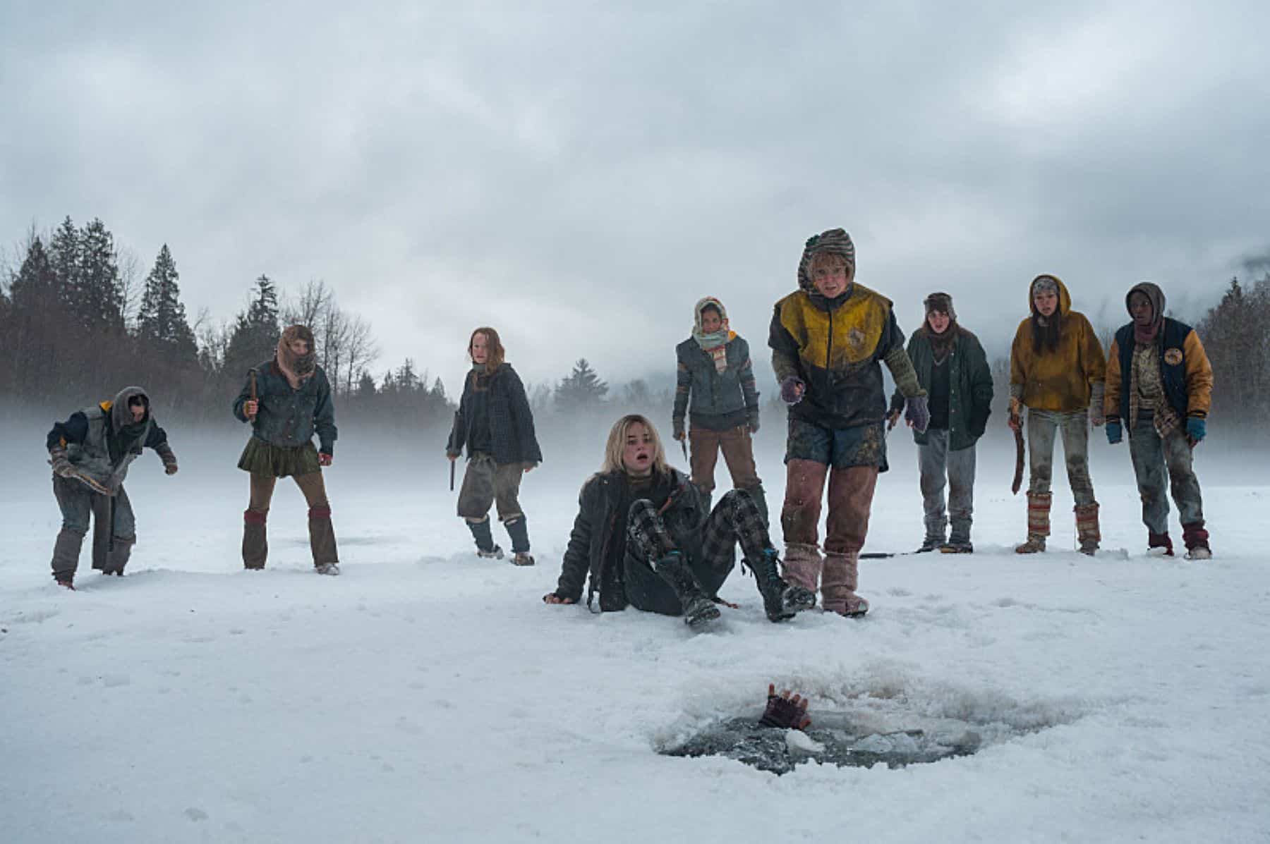 A group of girls surround someone drowning in a frozen lake in this photo by Showtime.