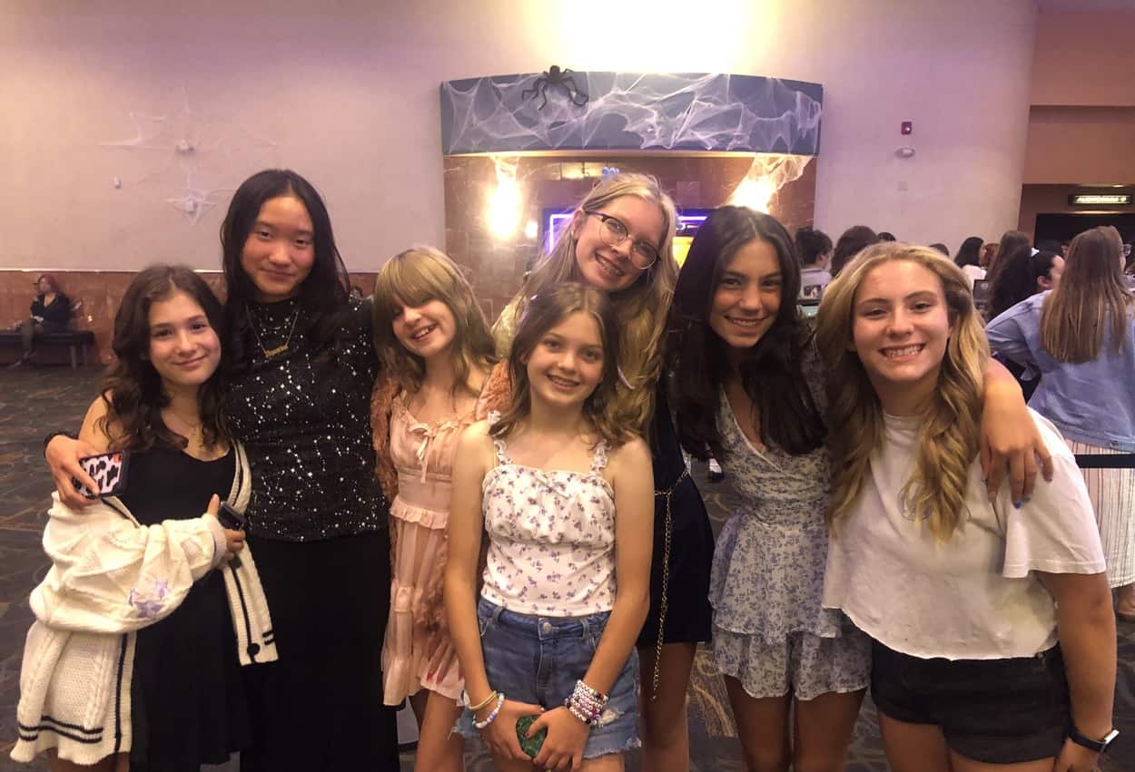 Seven girls are dressed up and ready for the Eras Tour in this image taken by the author. 