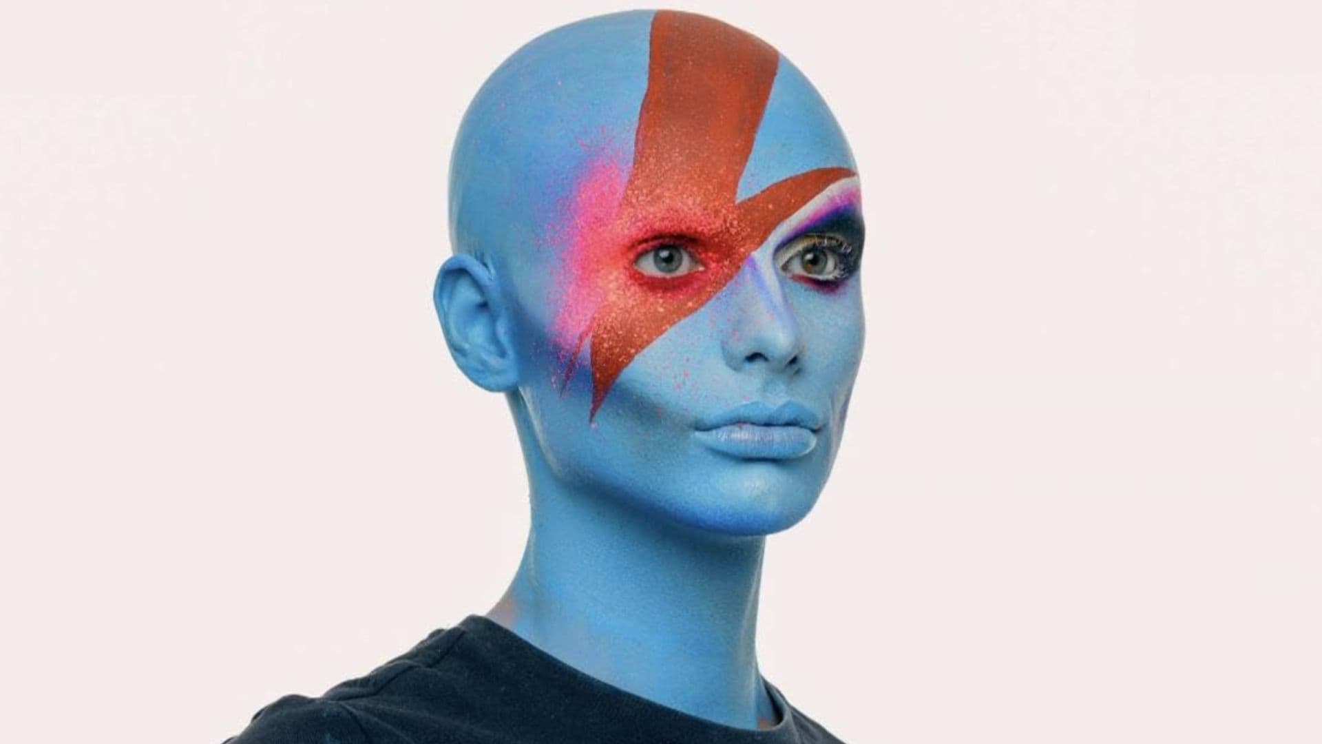 A model with blue face paint with red and pink details in this image from BBC Three.