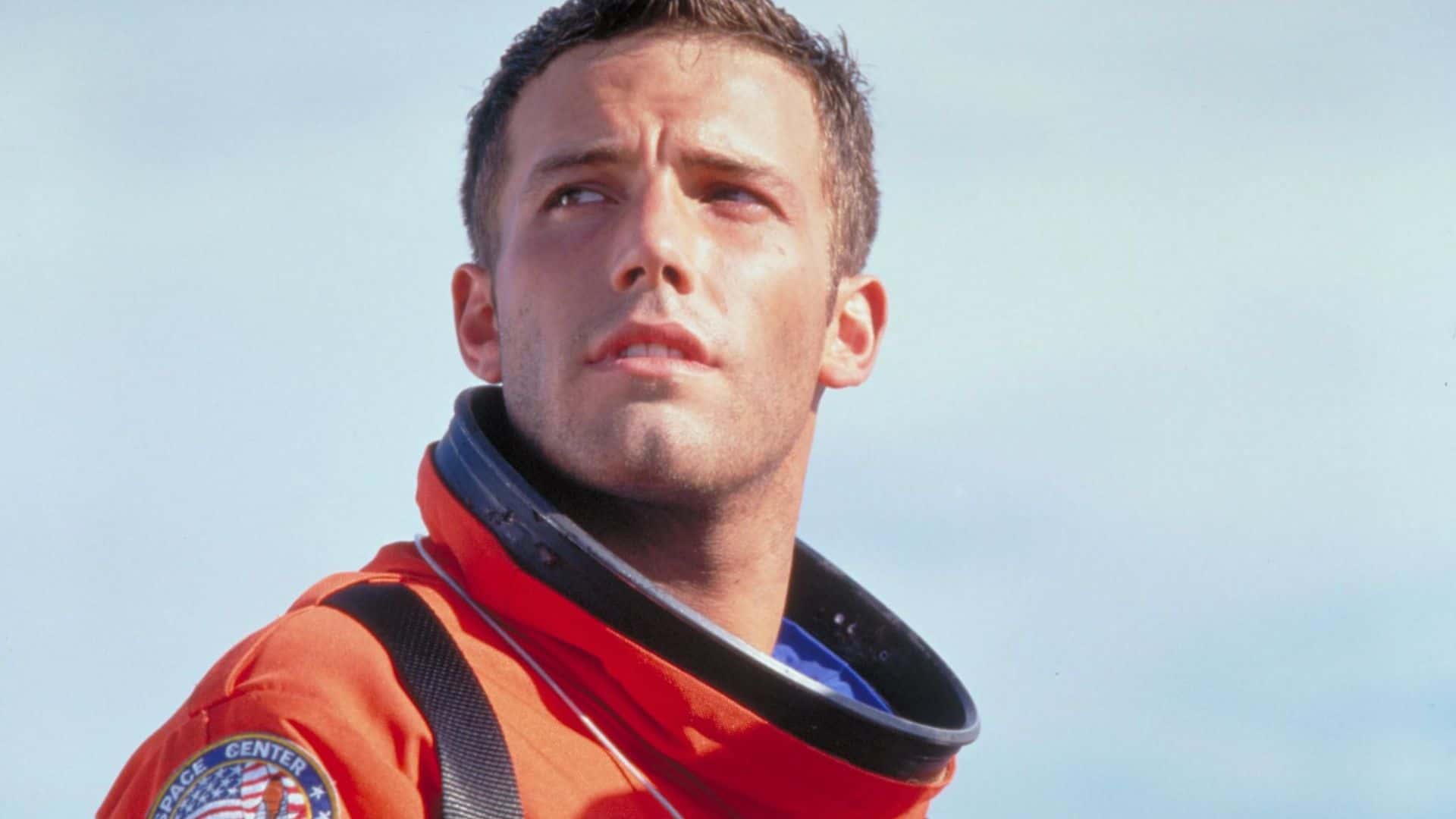 A man in an orange space suit in this image from Touchstone Pictures.