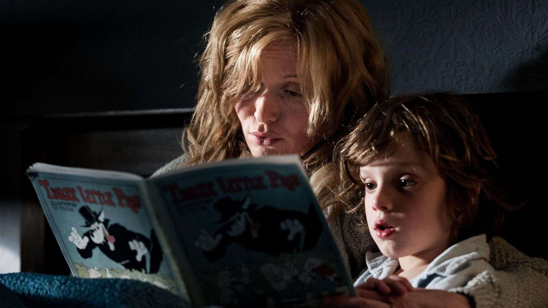 A woman and a young boy are reading a book in bed in this image from Causeway Films.