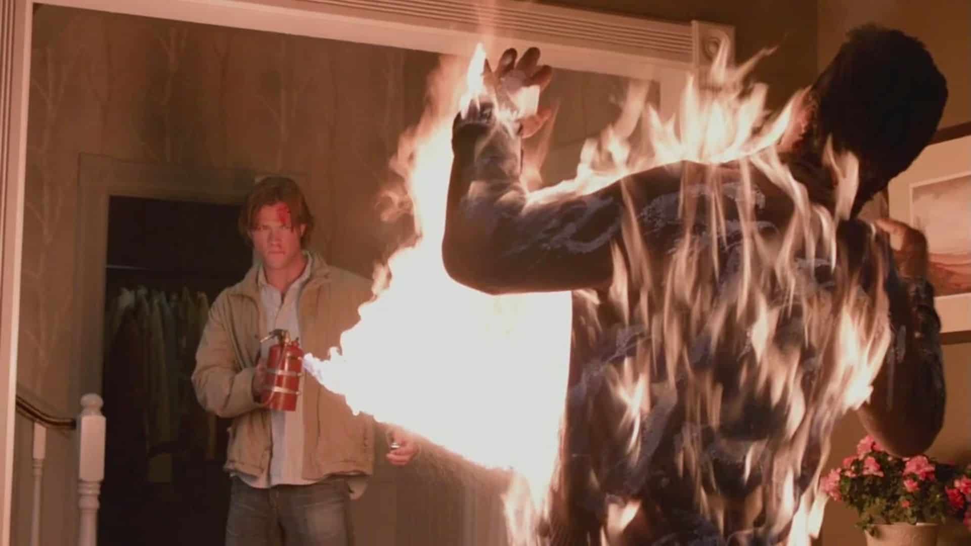 A man kills a rugaru with fire in this image from Warner Bros. Television.