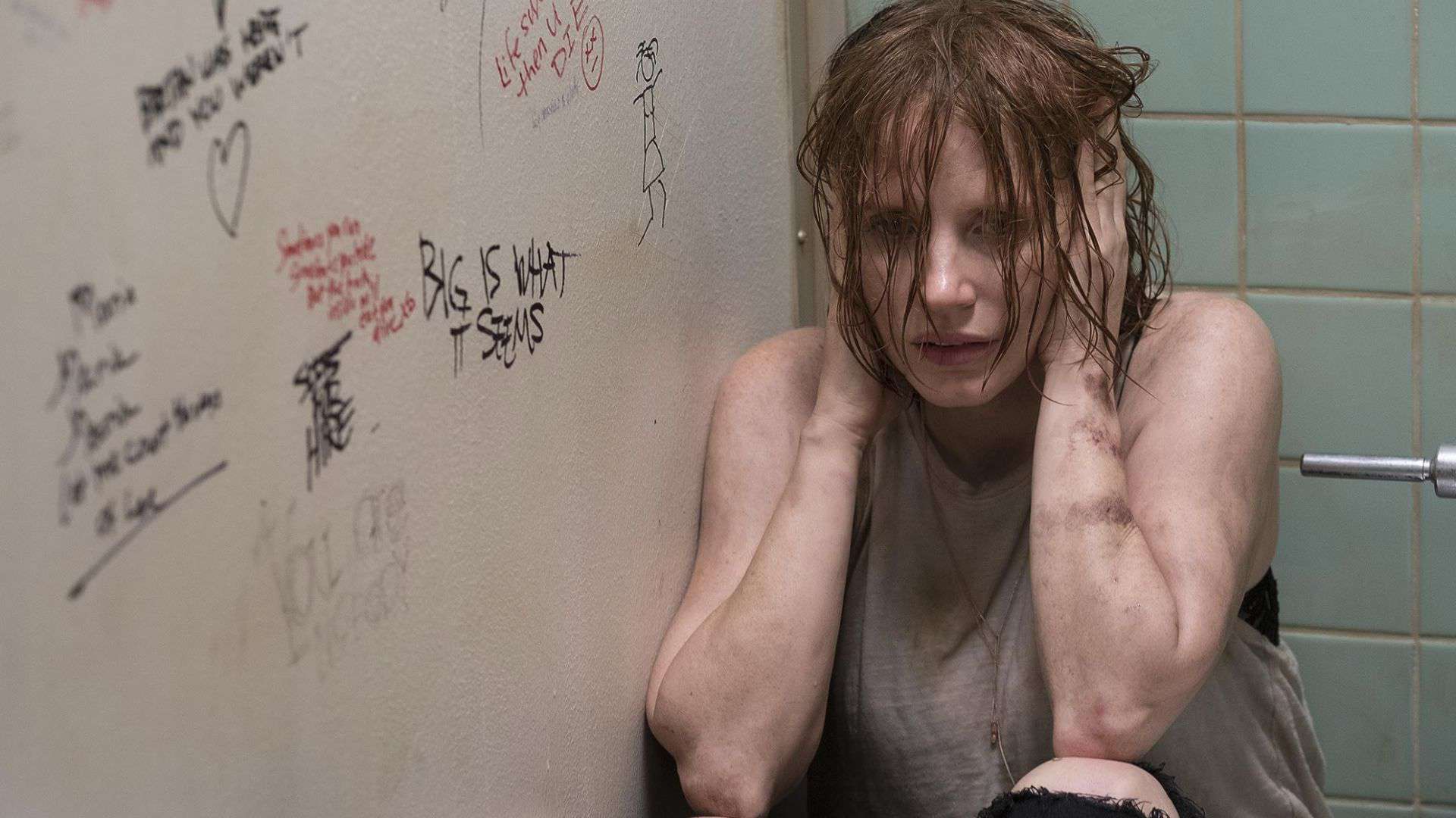 A woman hides in a bathroom stall in this image from New Line Cinema.