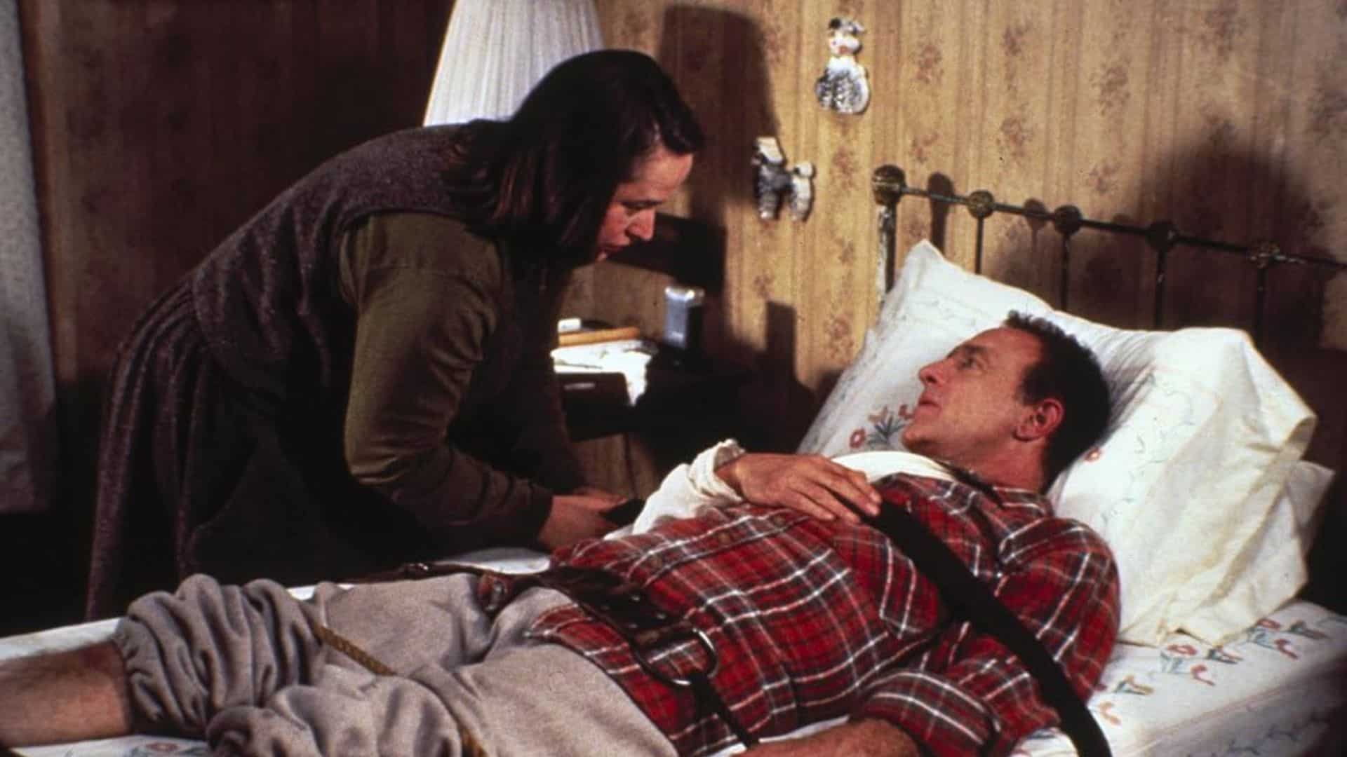 A woman straps a man to a bed in this image from Castle Rock Entertainment.