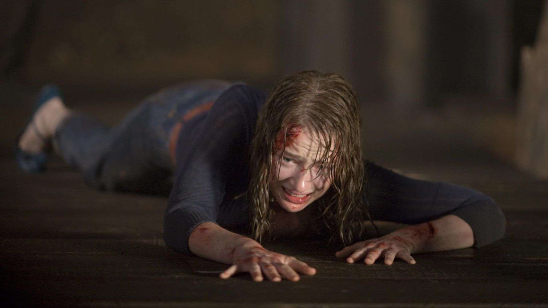  A woman with a head injury crawls on the floor in this image from Mutant Enemy Productions.