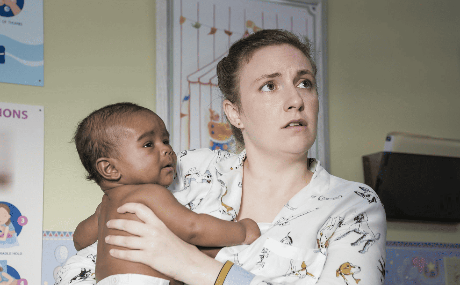 A woman holds a newborn child in this image from Apatow Productions.