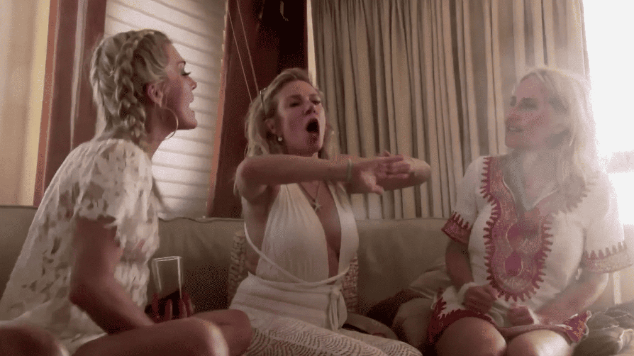 Three women fight while seated in the main salon of a motor yacht in this image from Shed Media.