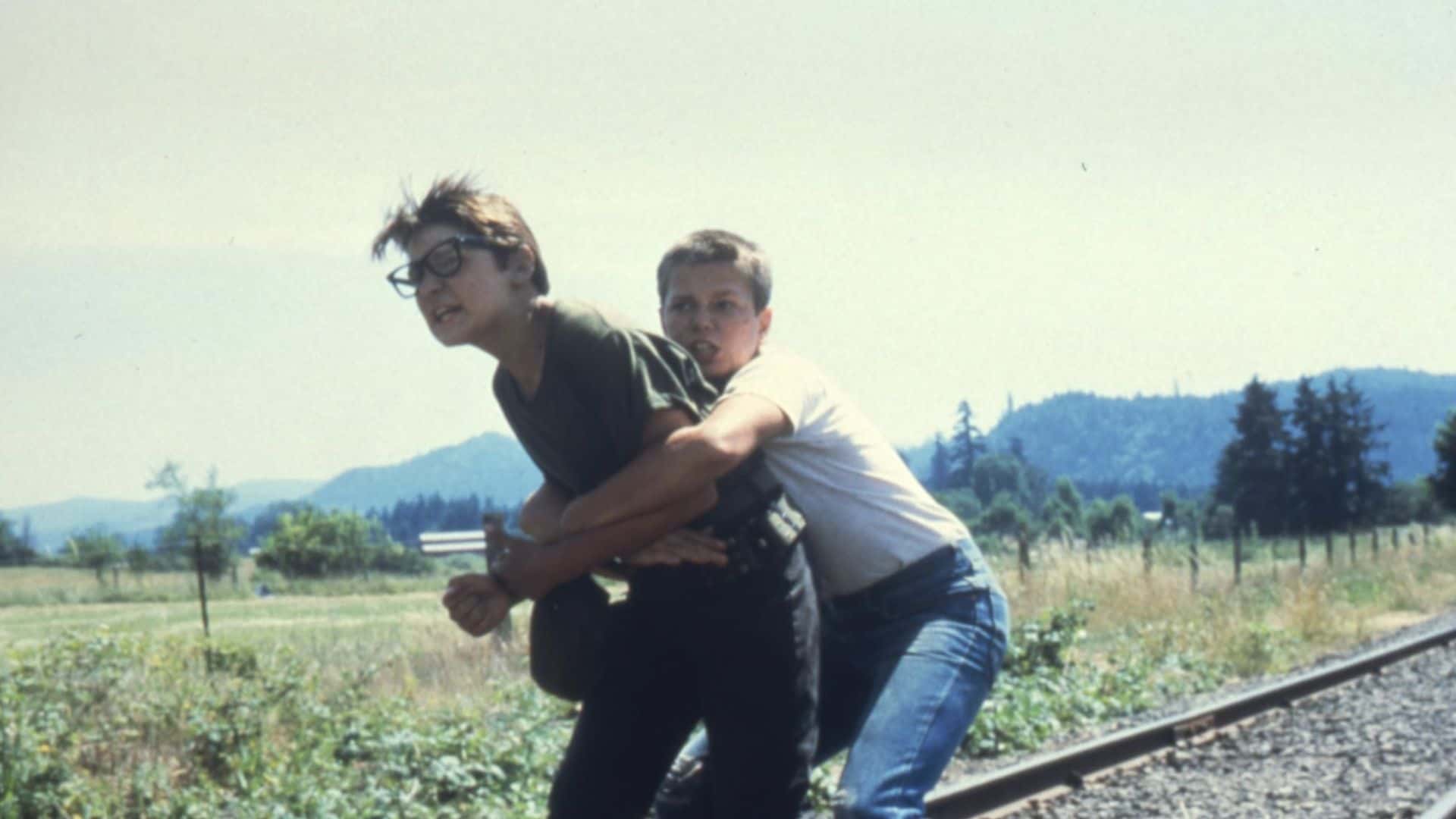 Two young boys struggle on train tracks in this image from Act III Productions.