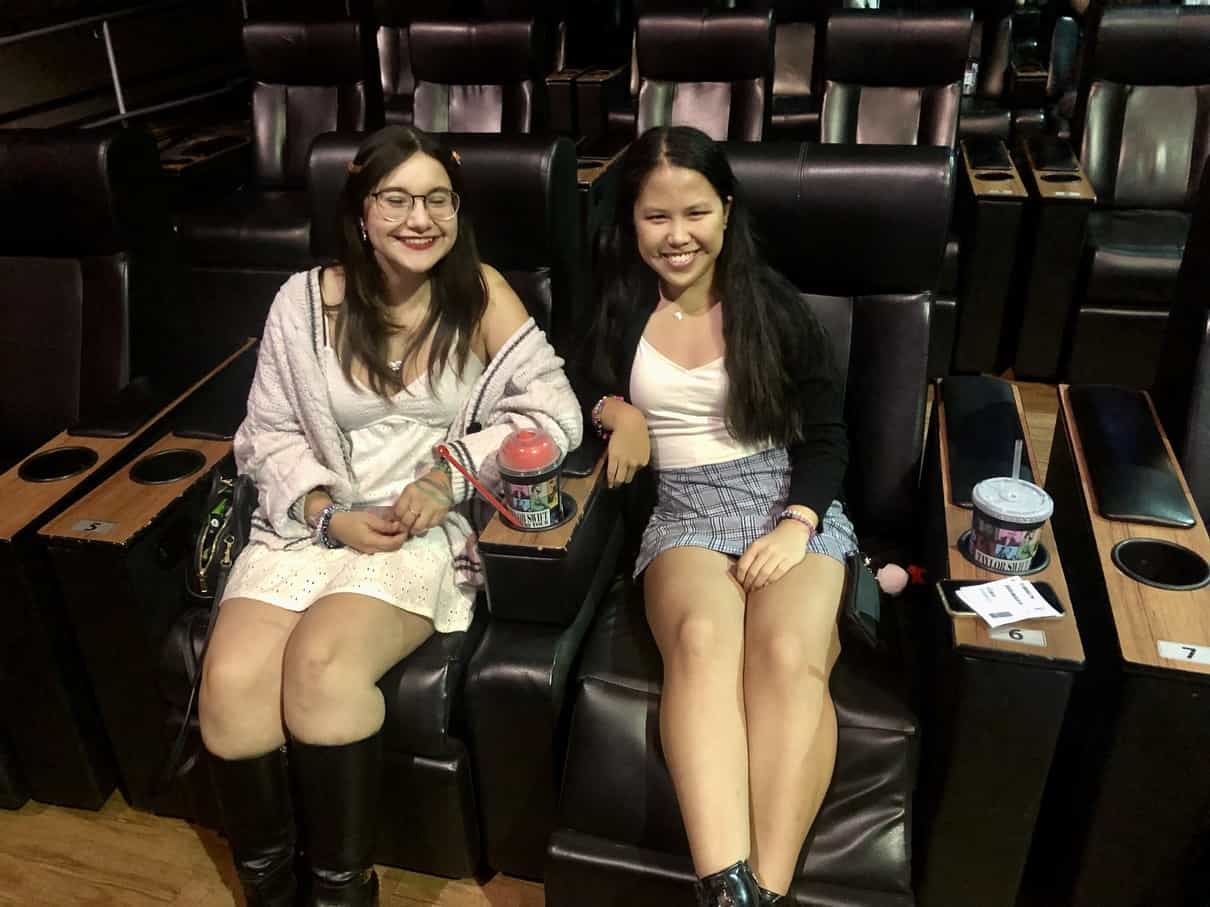 Two young women are seated for a movie in this image taken by the author. 
