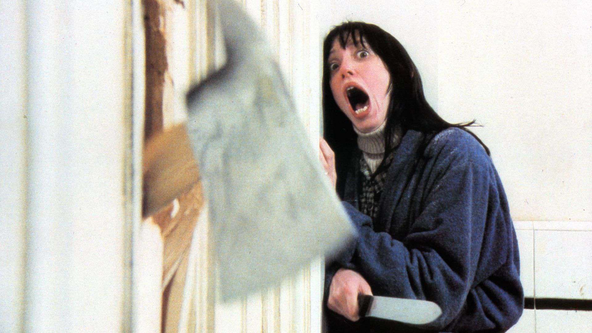A woman screams as a hatchet breaks through a door from The Producer Circle Company.