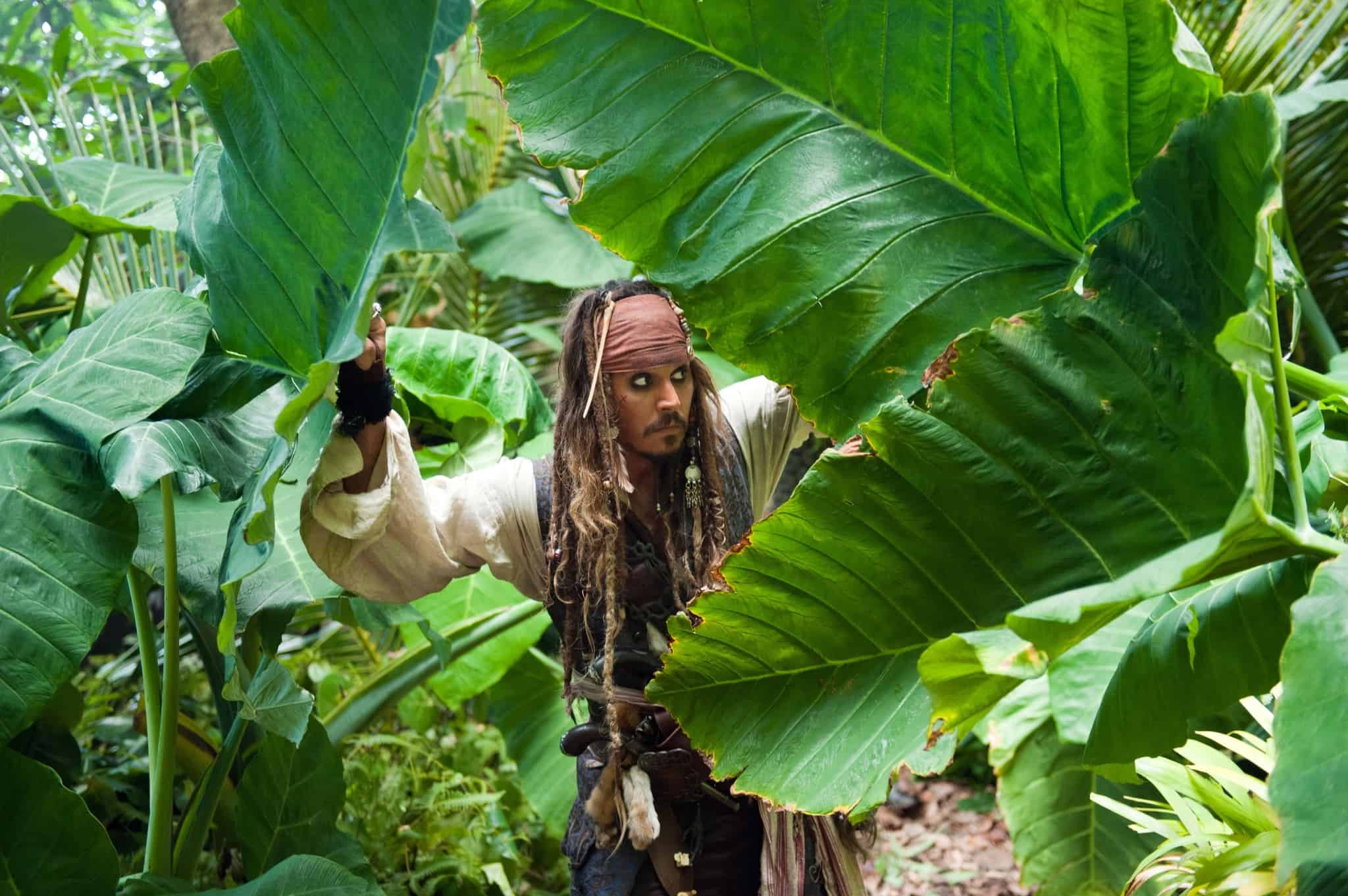 Captain Jack Sparrow trekking through the jungle in this photo from Walt Disney Pictures
