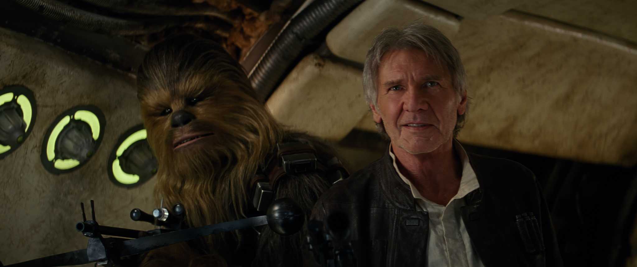 A wookiee and an older-looking man with guns raised on a spaceship in this photo from Lucasfilm