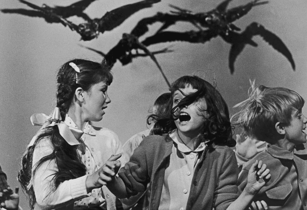 Children run from birds in this image from Alfred J. Hitchcock Productions.
