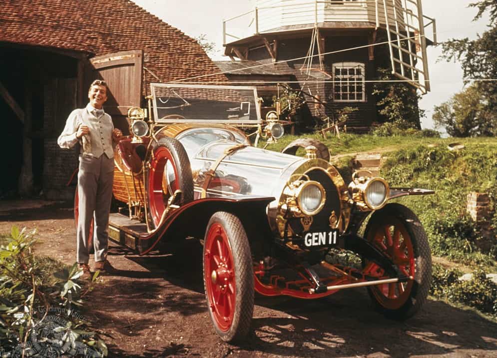 Dick Van Dyke standing next to a vintage car in this image from Dramatic Features.