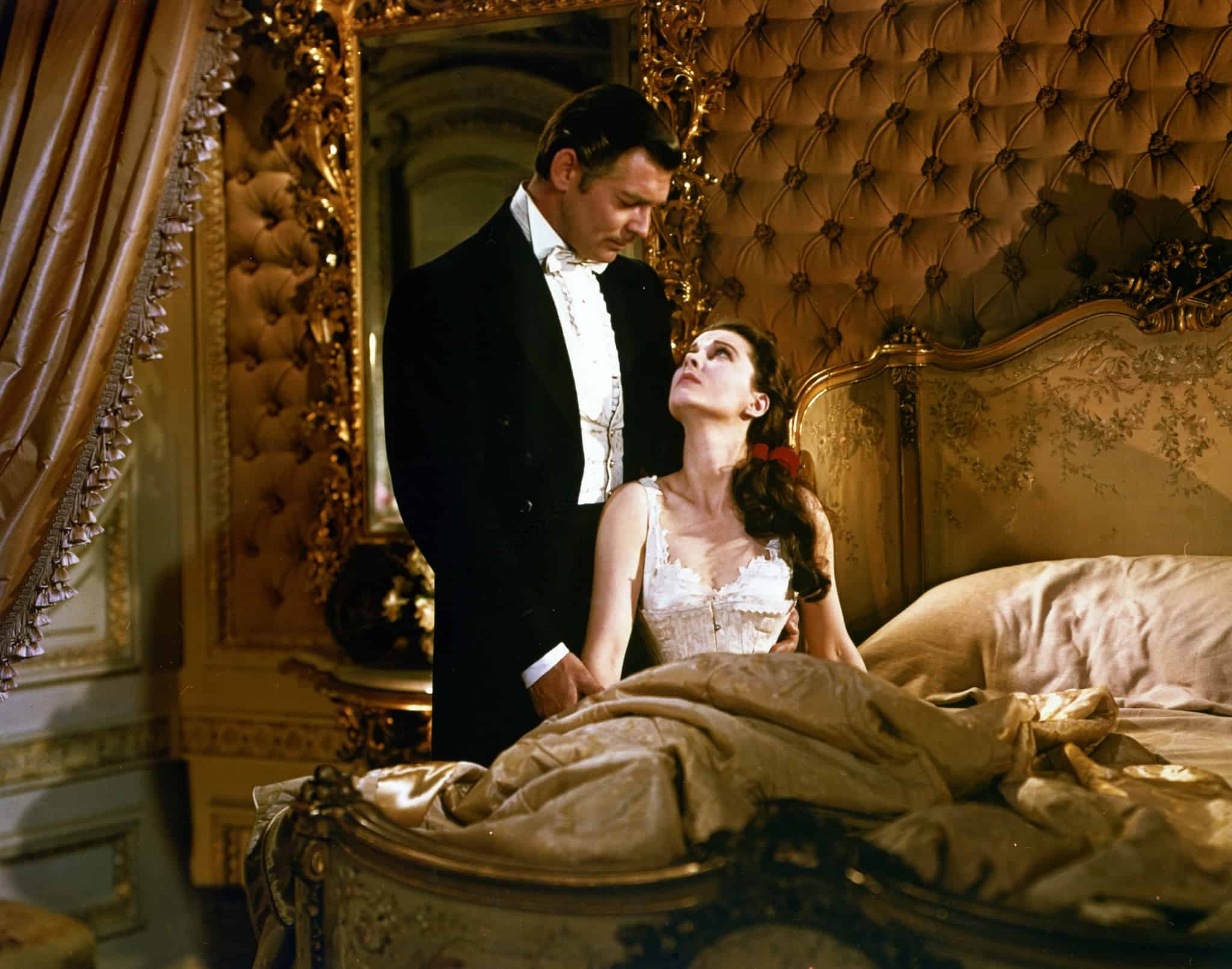 Clark Gable looking down on Vivien Leigh in bed in this image from Selznick International Pictures.