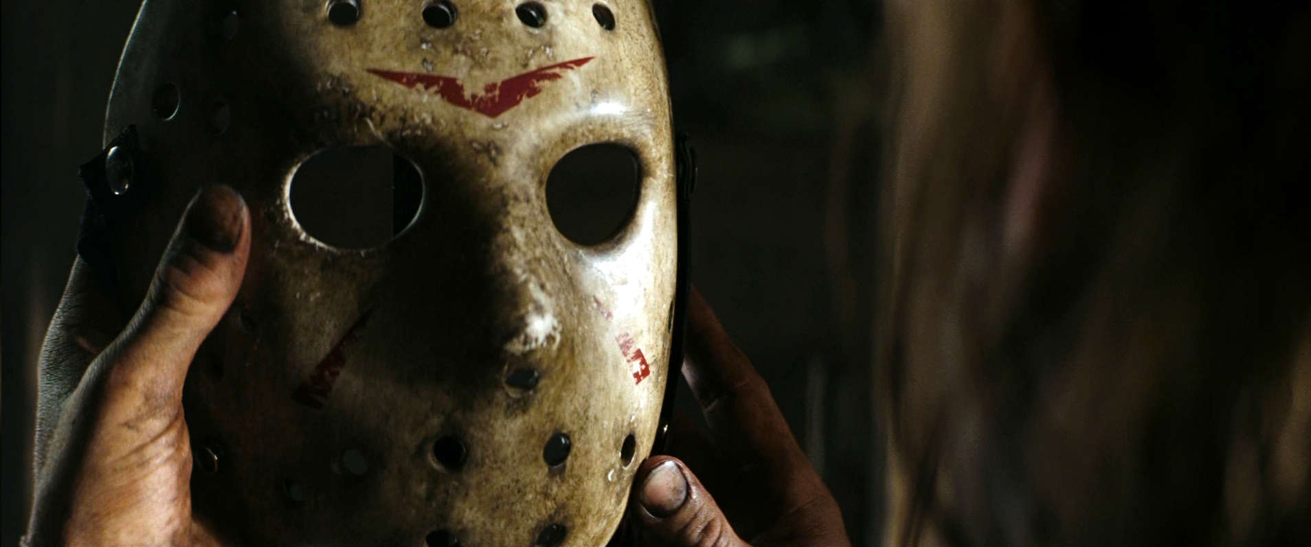 Hands holding a hockey mask in this photo from Paramount Pictures 