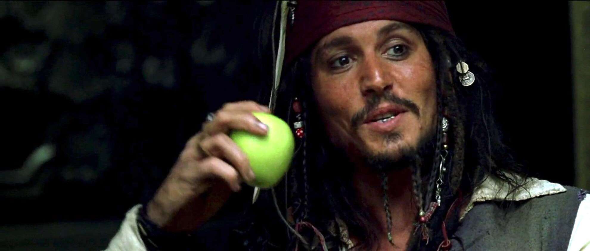Johnny Depp eats an apple in this image from Walt Disney Pictures.