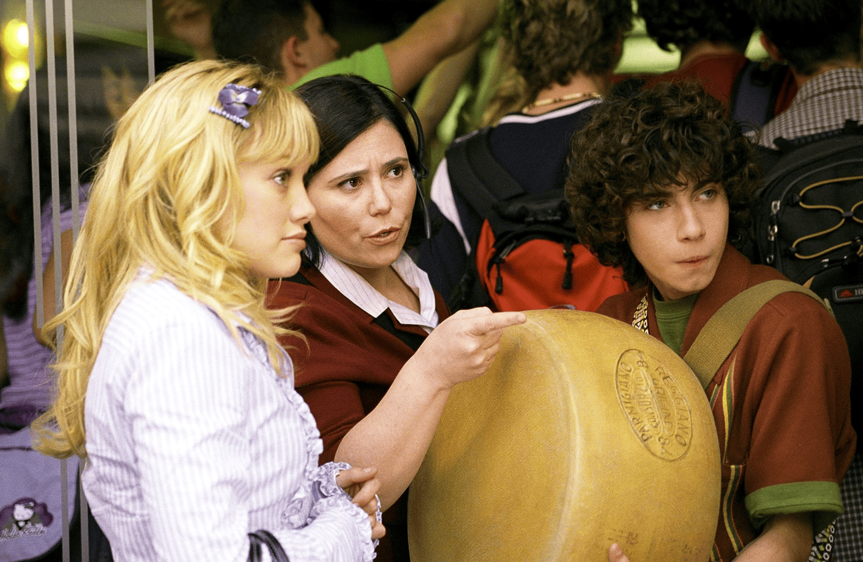 A girl and a boy hold a wheel of cheese in this image from Disney. 