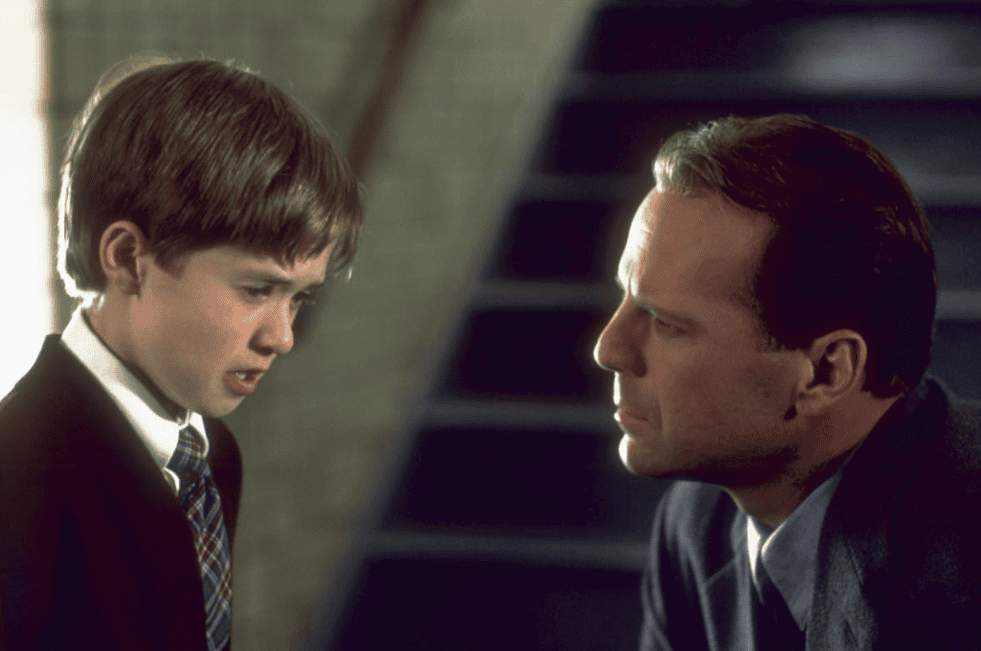 A young boy tearfully speaks to a man in this image from Hollywood Pictures.